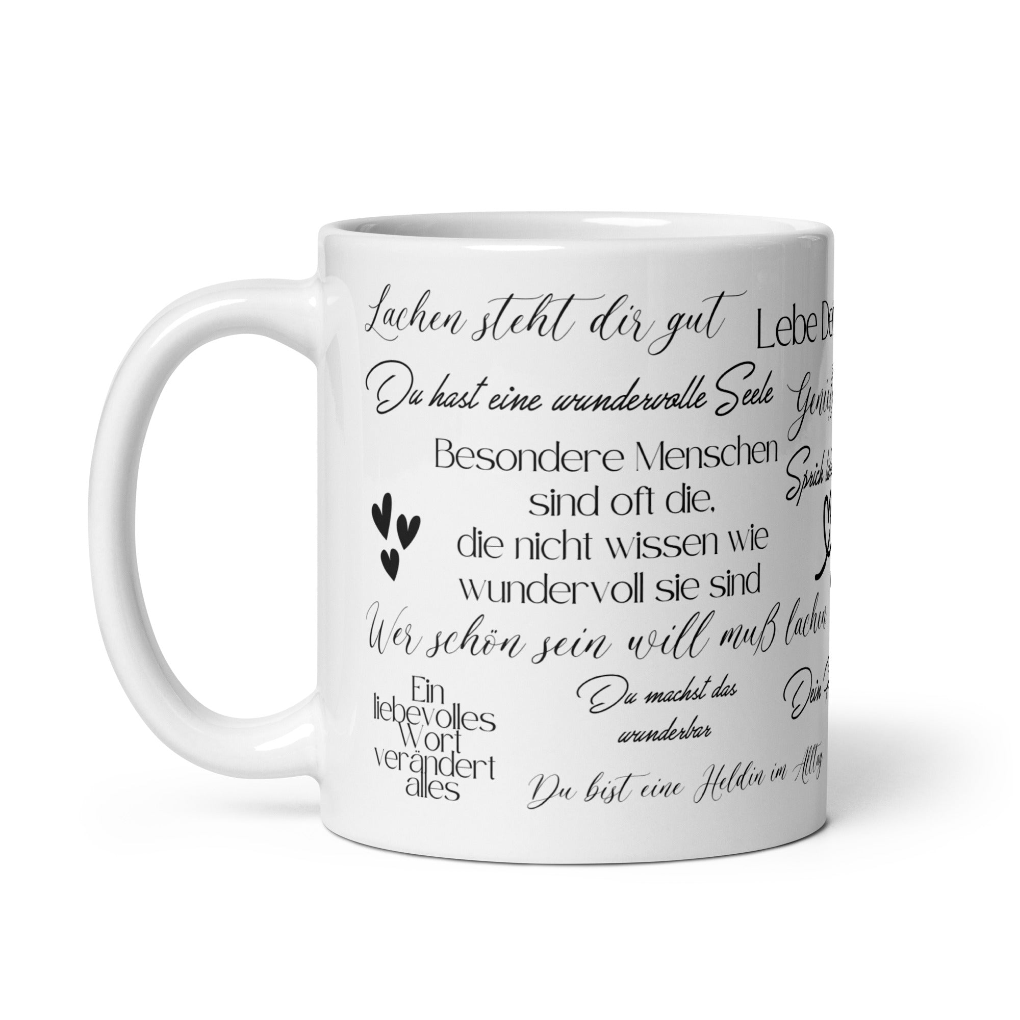 Weiße Keramiktasse mit schwarzem Motivationsspruch „Lachen steht dir gut“ auf weißem Hintergrund.